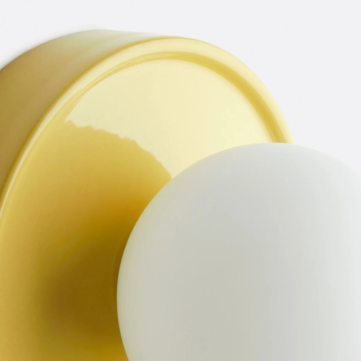 Glossy yellow ceramic wall lamp detail