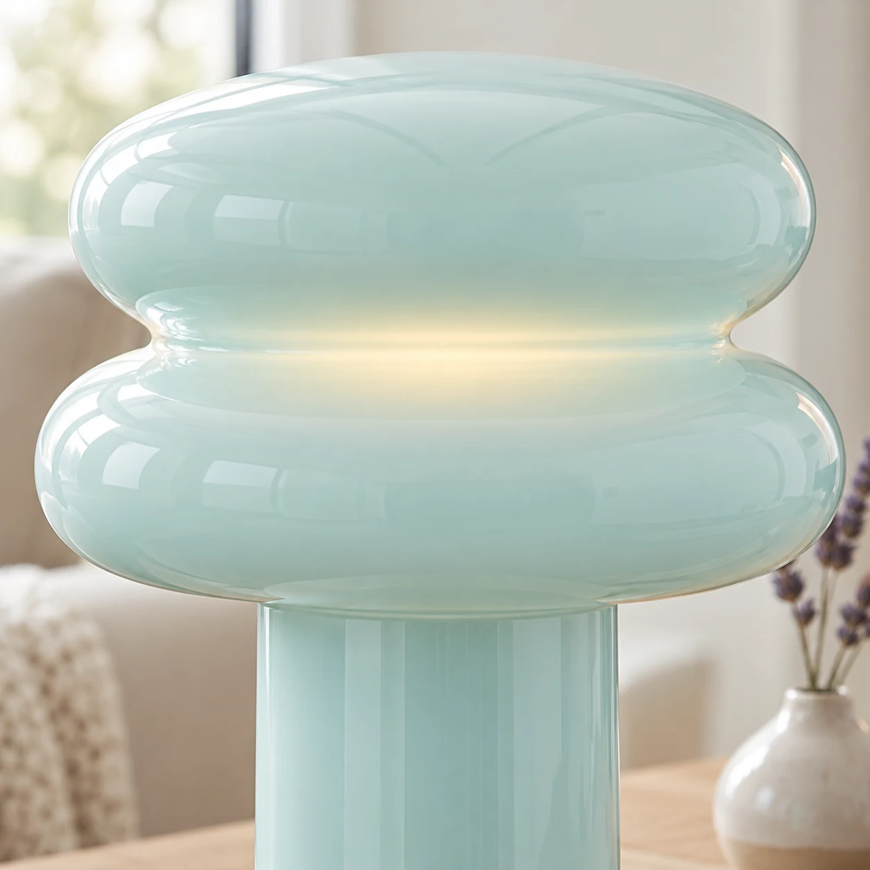 Close view of the Orra lamp's smooth colored opal glass and curved form